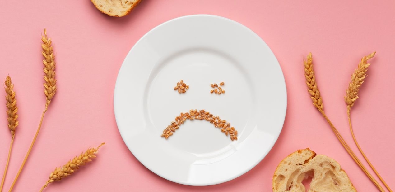Prato branco com grãos formando um rosto triste, simbolizando a relação difícil com a comida e o transtorno alimentar