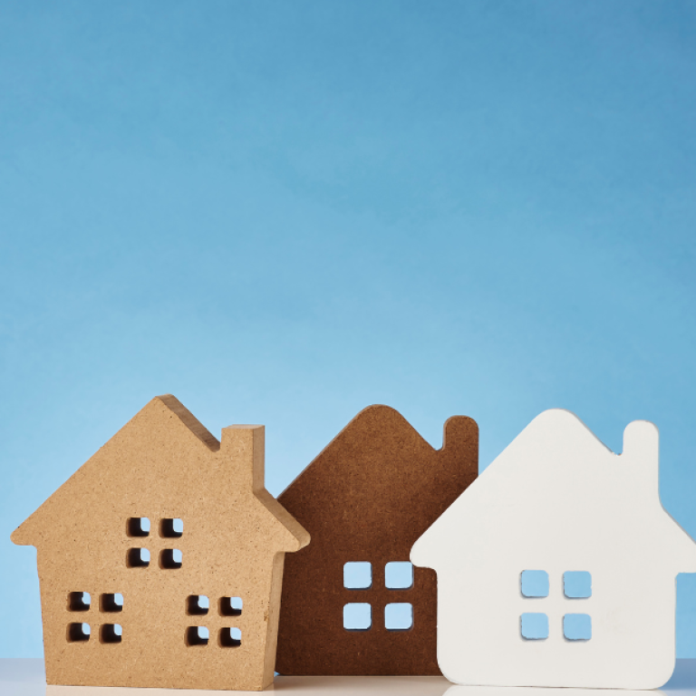 Casas decorativas em tons neutros simbolizando diferentes estilos de moradia e bem-estar psicológico